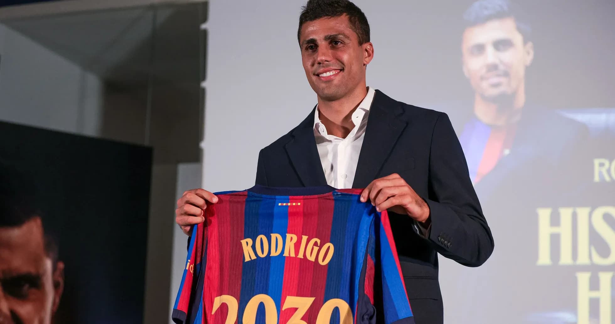 Player holding Barcelona jersey at press conference Player holding Barcelona jersey at press conference