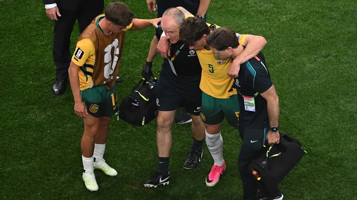 Player receiving assistance from staff after injury Player receiving assistance from staff after injury