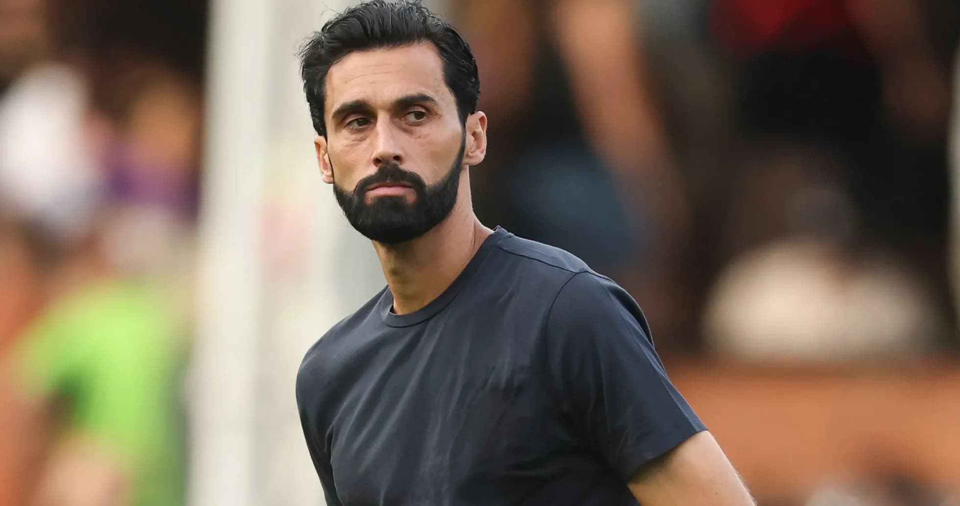 Man in black shirt on sports field Man in black shirt on sports field