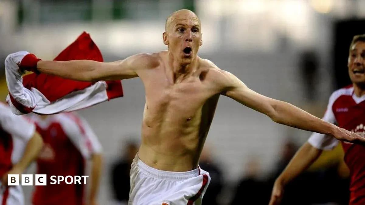 Player celebrating a goal with shirt raised Player celebrating a goal with shirt raised
