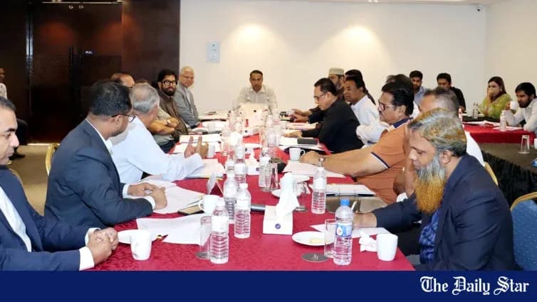Group meeting around a conference table with documents Group meeting around a conference table with documents