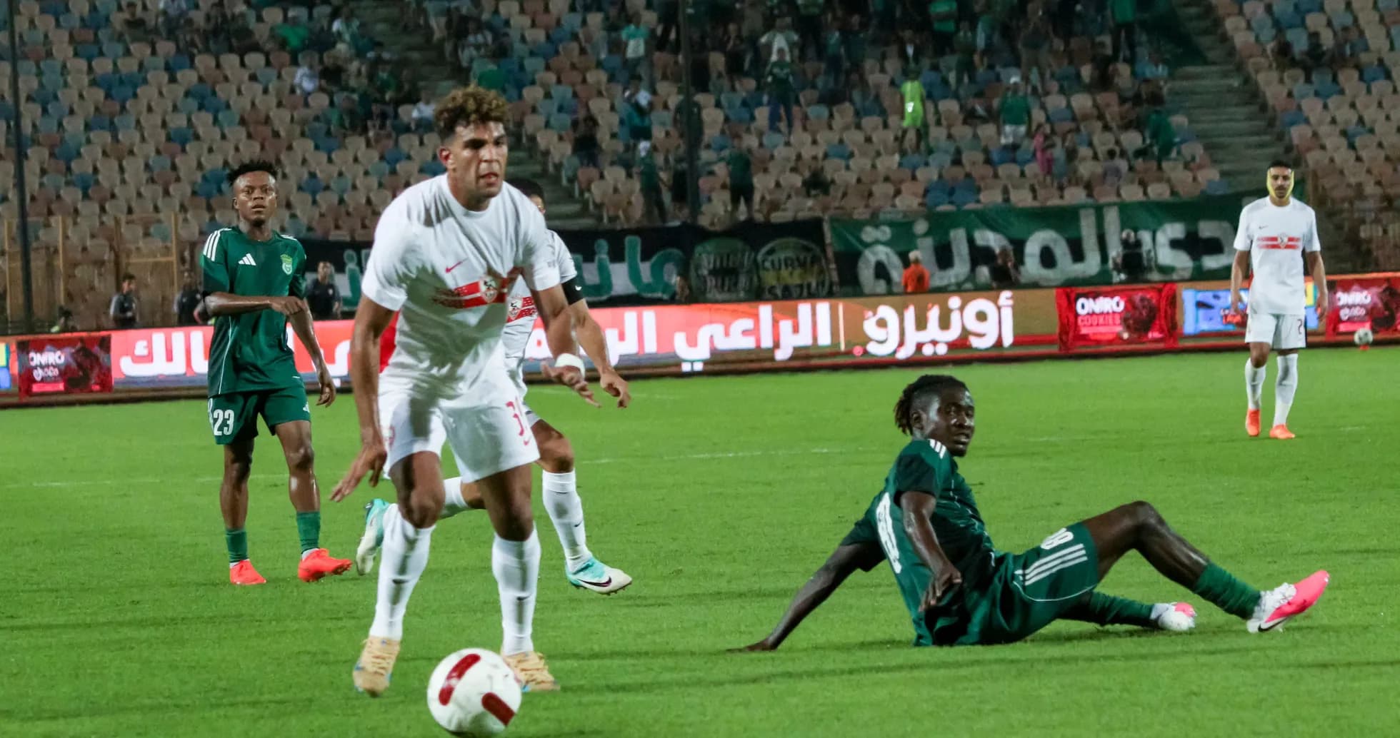 Zamalek player evading a tackle during match Zamalek player evading a tackle during match