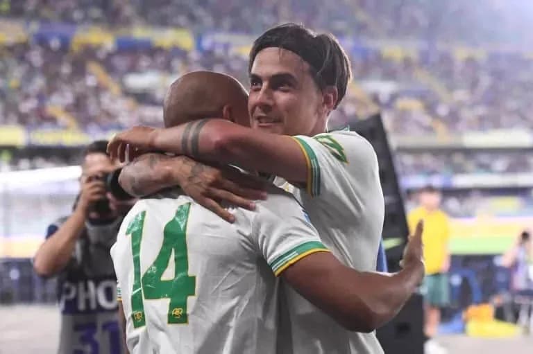Two players embracing on the pitch after match Two players embracing on the pitch after match