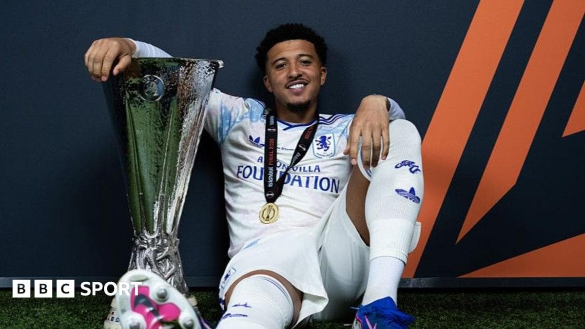 Player celebrating with UEFA trophy and medal Player celebrating with UEFA trophy and medal