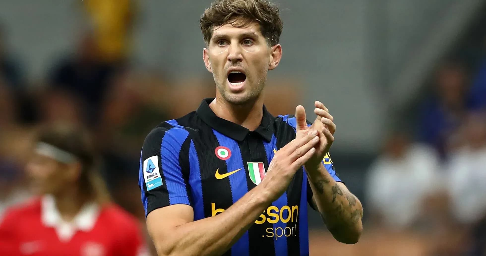 Player in blue and black jersey gesturing on field Player in blue and black jersey gesturing on field