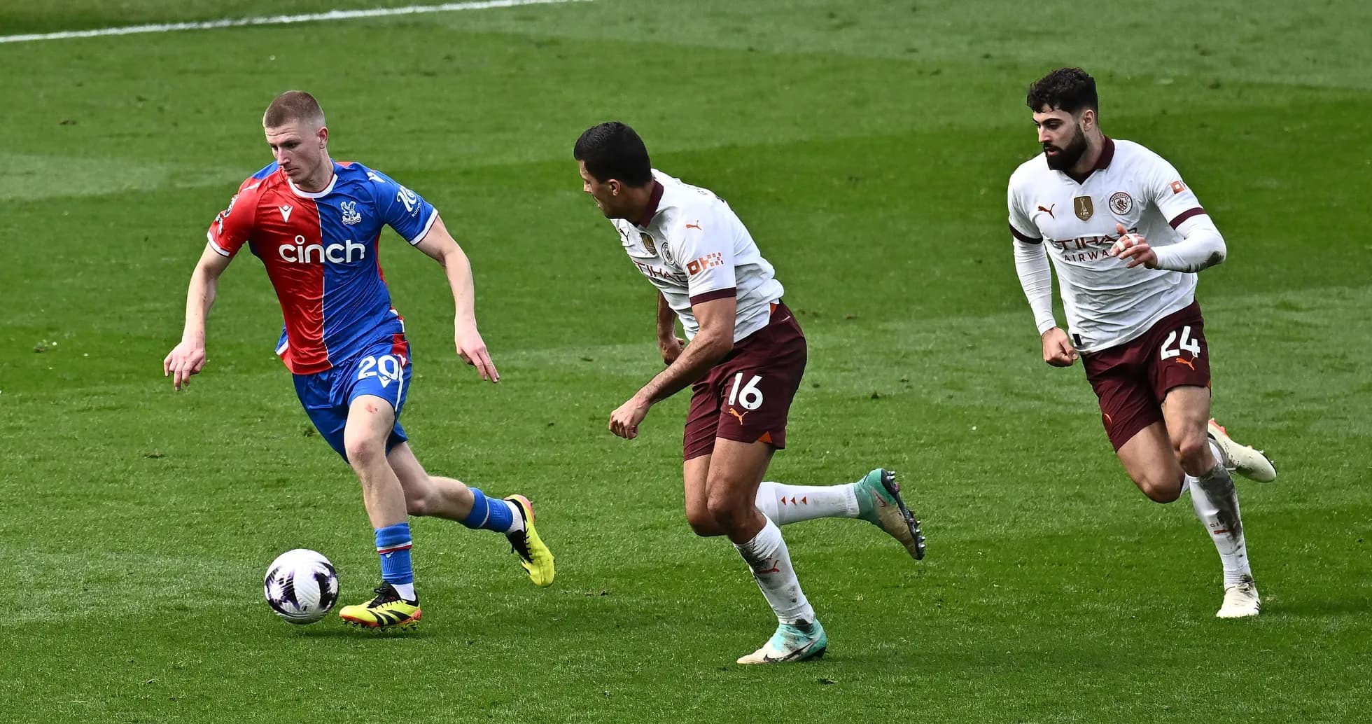 Player dribbling the ball with defenders in pursuit Player dribbling the ball with defenders in pursuit