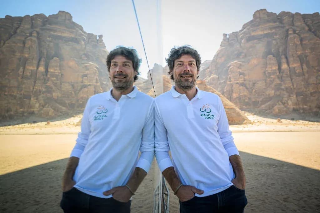Man posing in desert with mountains in background Man posing in desert with mountains in background