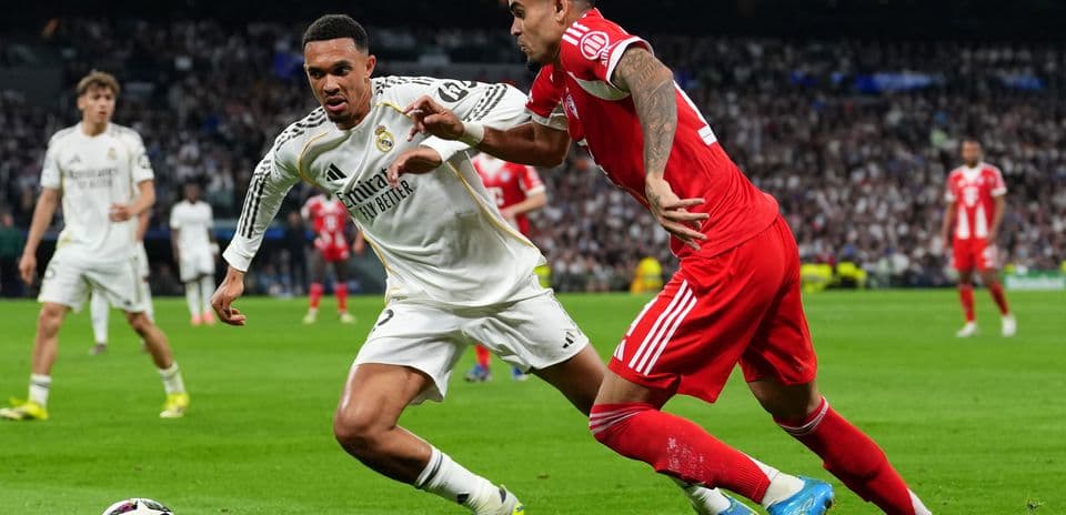 Real Madrid player challenging Bayern München opponent Real Madrid player challenging Bayern München opponent