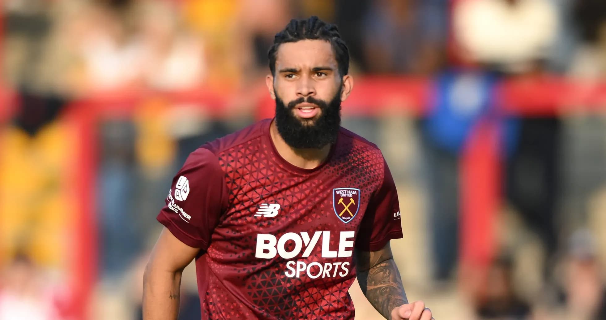 Player in West Ham United jersey on the field Player in West Ham United jersey on the field