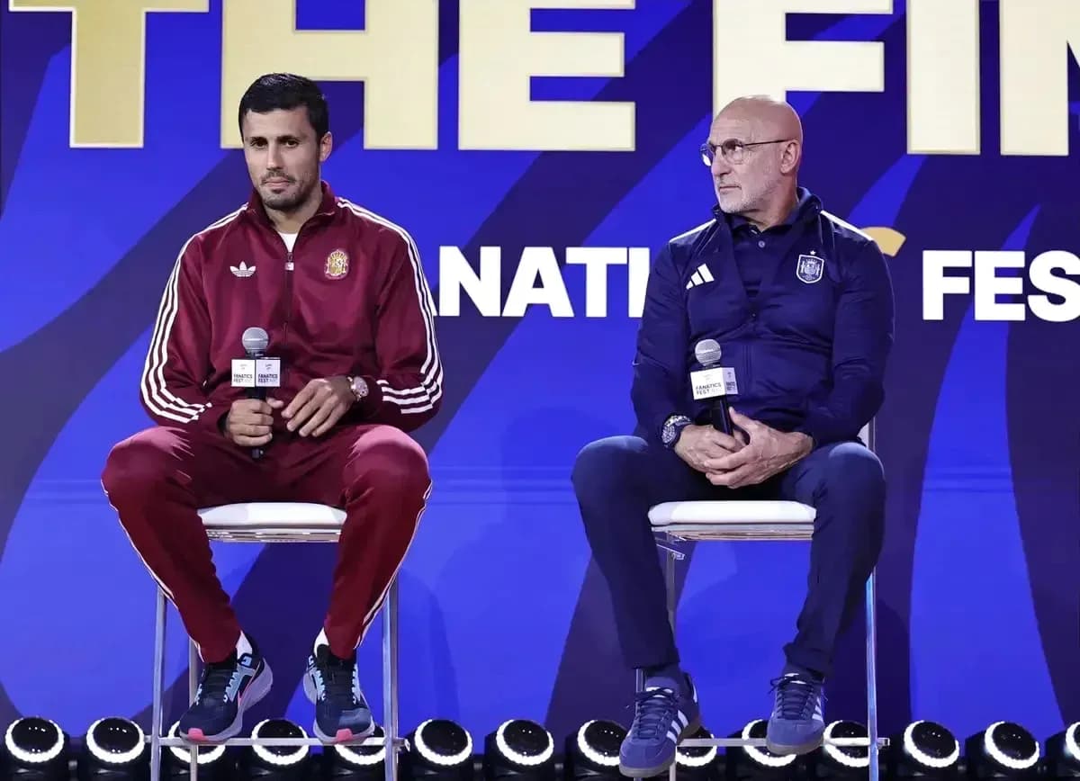 Coaches seated at press conference with microphones Coaches seated at press conference with microphones