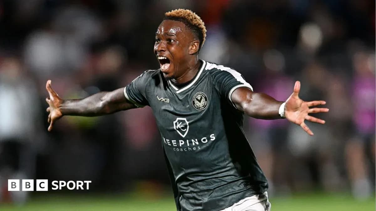 Player celebrating a goal on the pitch Player celebrating a goal on the pitch