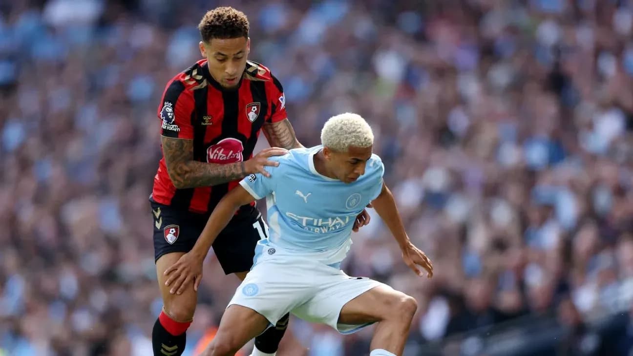 Player from Bournemouth tackling Manchester City player Player from Bournemouth tackling Manchester City player