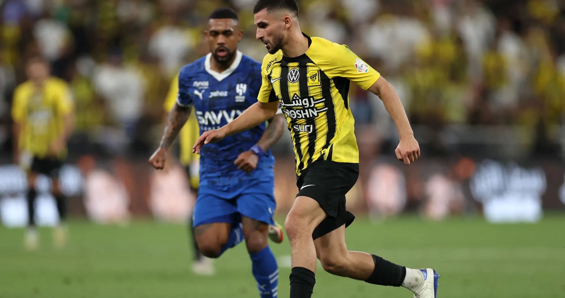 Player in yellow dribbling the ball during match Player in yellow dribbling the ball during match