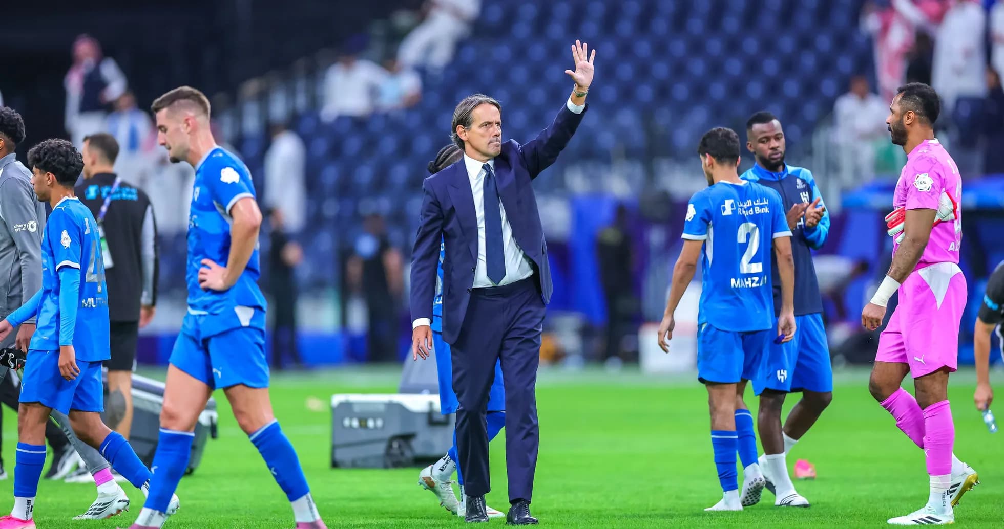 Coach waving to players after the match Coach waving to players after the match