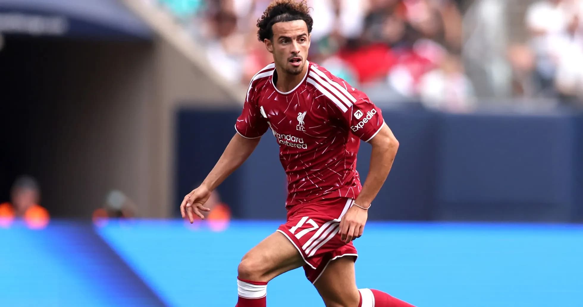 Player in Liverpool kit running on the pitch Player in Liverpool kit running on the pitch
