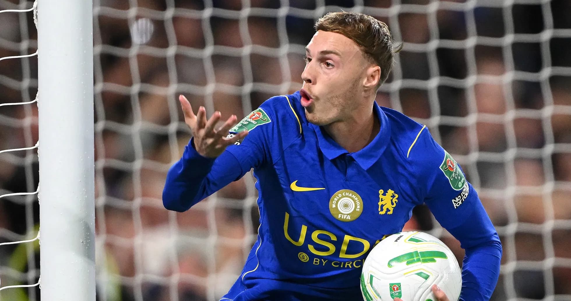 Player gesturing while holding the ball in goal area Player gesturing while holding the ball in goal area