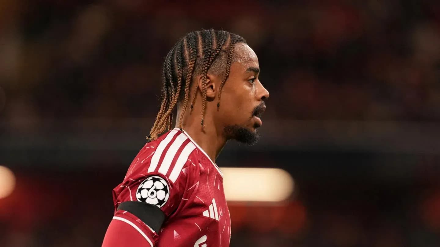 Player in red jersey during match with Champions League logo Player in red jersey during match with Champions League logo