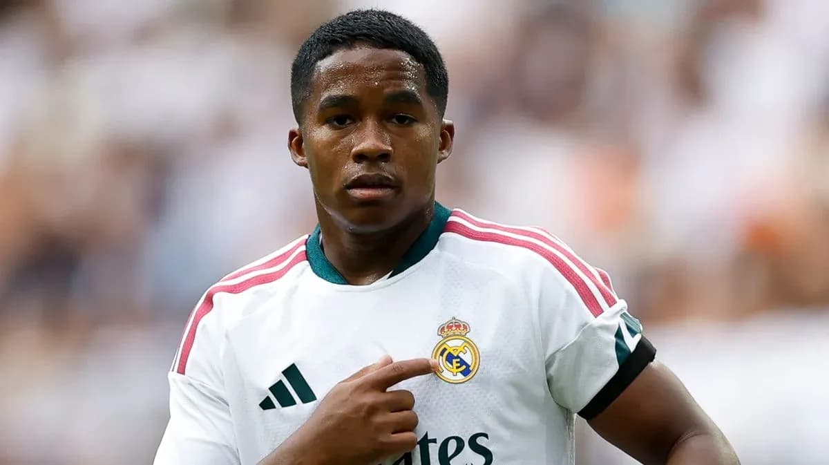 Player pointing at Real Madrid badge on jersey Player pointing at Real Madrid badge on jersey