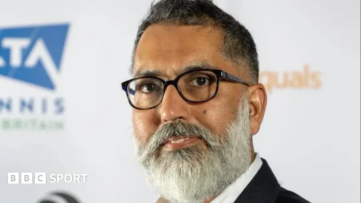 Man with glasses and beard at event backdrop Man with glasses and beard at event backdrop