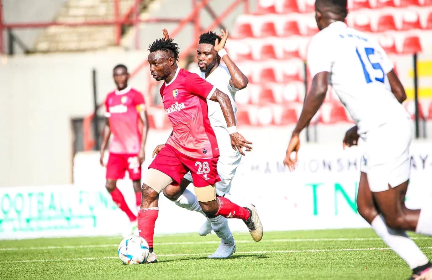 Katsina United player dribbling against Rivers United Katsina United player dribbling against Rivers United