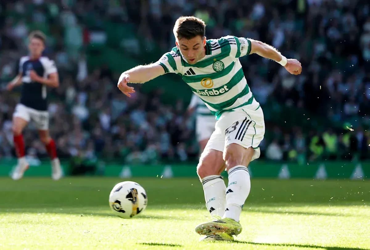 Celtic player kicking the ball during match Celtic player kicking the ball during match