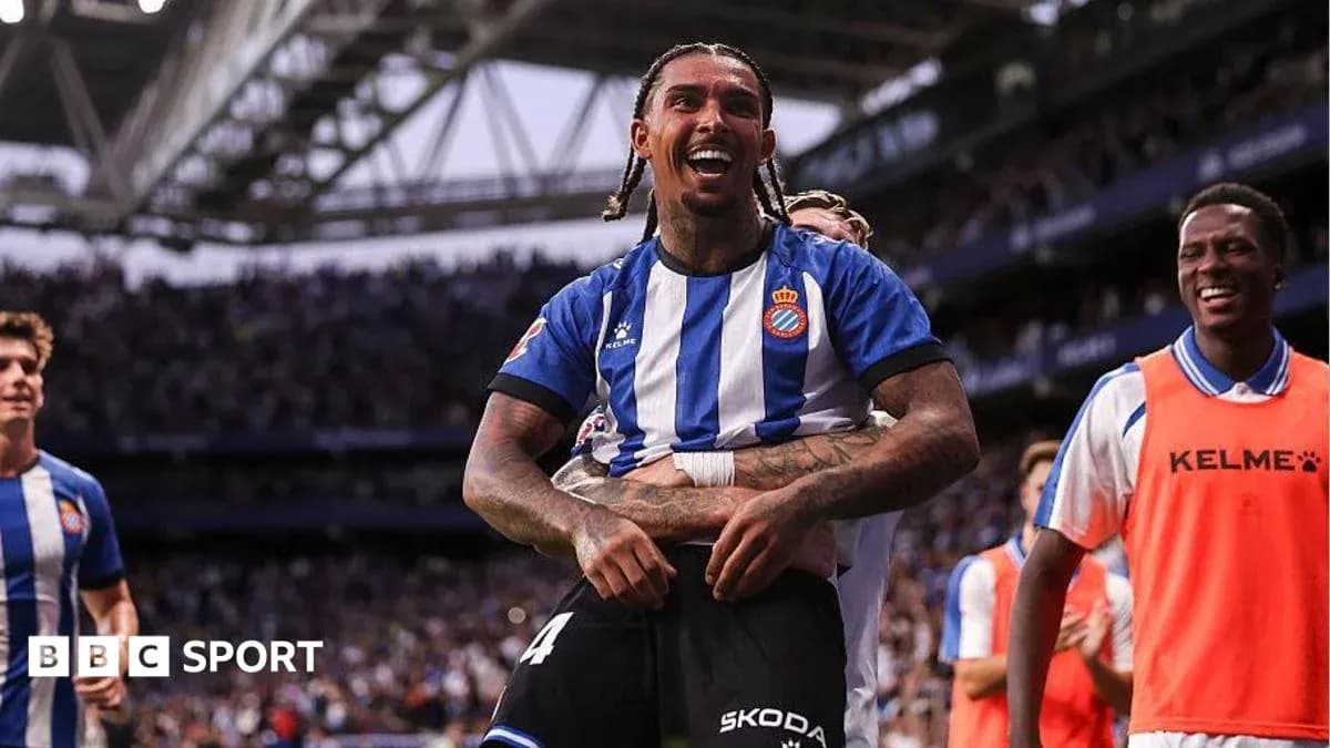 Espanyol players celebrating a goal on the pitch Espanyol players celebrating a goal on the pitch