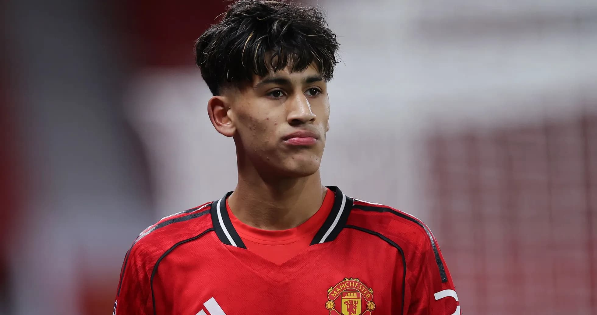 Young player in Manchester United kit during match Young player in Manchester United kit during match