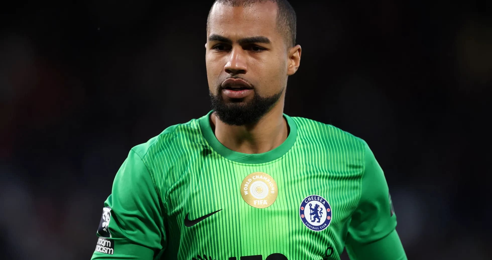 Goalkeeper wearing green kit with Chelsea badge Goalkeeper wearing green kit with Chelsea badge
