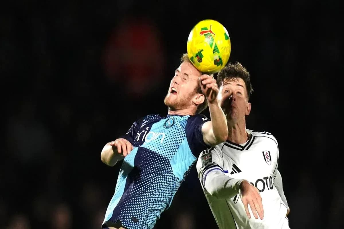 Two players contesting a header during football match Two players contesting a header during football match