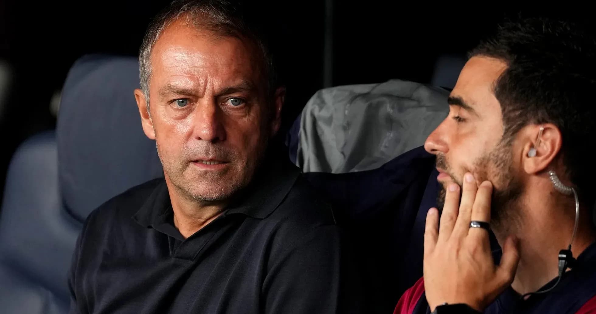 Two coaches discussing on the bench during match Two coaches discussing on the bench during match