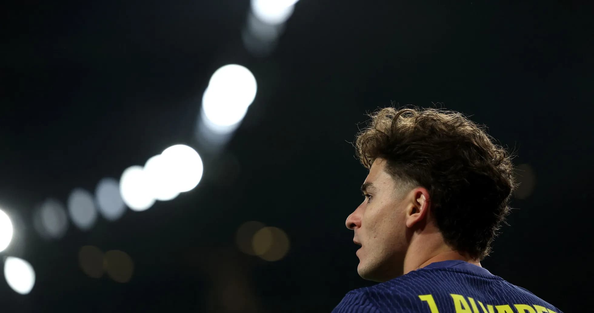 Player with curly hair looking away during match Player with curly hair looking away during match