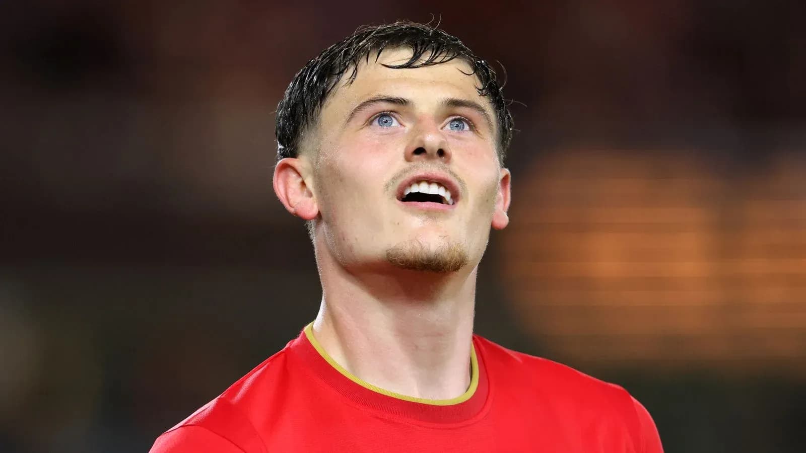 Player in red jersey looking upwards during match Player in red jersey looking upwards during match