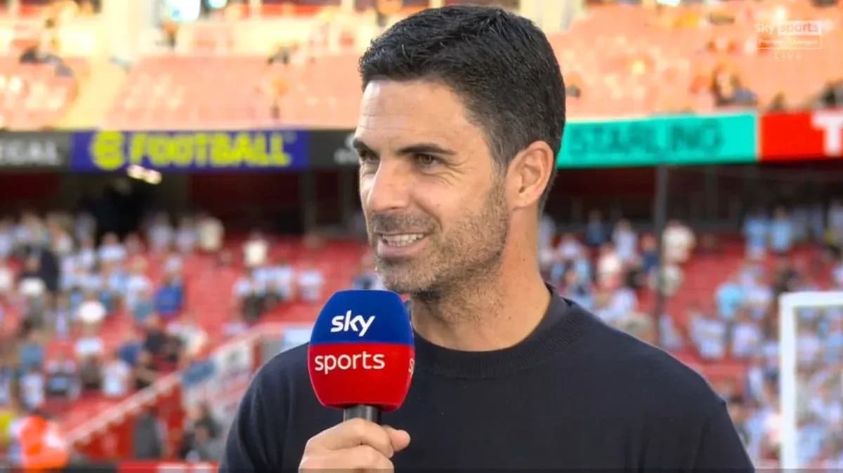 Manager speaking during pre-match interview on field Manager speaking during pre-match interview on field