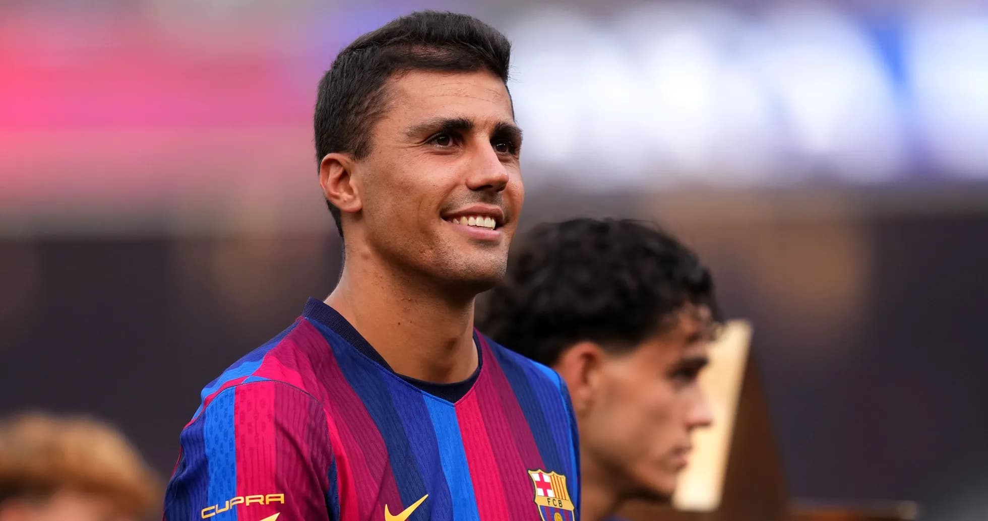 Player smiling while wearing FC Barcelona jersey Player smiling while wearing FC Barcelona jersey