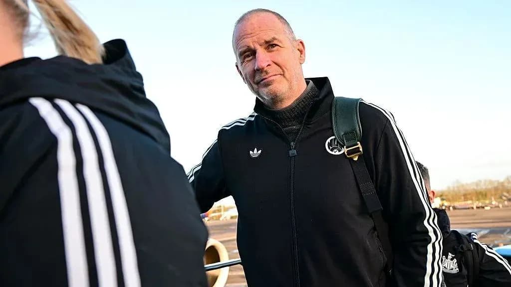 Coach in team tracksuit at airport boarding Coach in team tracksuit at airport boarding